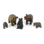 Five Black Forest style carved miniature bears, two large, 5cm high, and three small, 4cm high.
