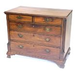 A George III mahogany chest of drawers, the top with a moulded edge, above two short and three long