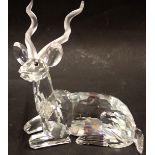 A Swarovski crystal figure of a seated antelope, 11cm high, boxed.