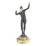 An Art Deco style bronzed metal figure of a male dancer, with simulated ivory head and hands, on a s