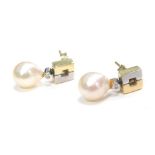 A pair of cultured pearl and diamond drop earrings, with bicolour box design and tiny diamond with c