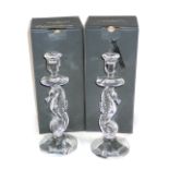 A pair of Waterford crystal candlesticks, each with a seahorse shaped column and a faceted tapering