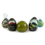 A collection of five Medina glass paperweights, in typical colours, two bearing labels, 13cm high.