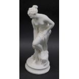 An early 20thC neo-classical plaster figure of a lady bathing, on a circular beaded base, 28.5cm hig