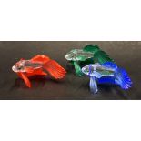 Three Swarovski crystal fish, each with flared fins, in blue, green and red, 8cm wide. (3, boxed)