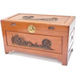 An oriental camphorwood chest, with carved sides and brass lock etc, 57cm high, 100cm wide, 52cm dee
