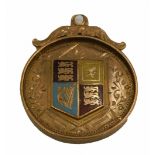A 9ct gold shield fob, with scroll top, and an enamel central shield, with blue, red and yellow enam