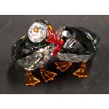 A Swarovski crystal figure group of two puffins, 5cm high, boxed.
