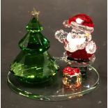 A Swarovski crystal Christmas dome, with Christmas tree, Santa and present, 5.5cm high, and a dome t