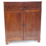 A Victorian mahogany cabinet, with two drawers over two panelled doors with press interior drawers,