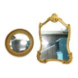 Two gilt framed wall mirrors, comprising a fluted and shell capped mirror, 91cm high, 54cm wide, and