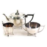 A silver plated Art Deco three piece tea set, the teapot with leather bound handle.
