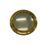 A brass porthole mirror, 38cm diameter.