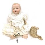An early 20thC JDK Hilda bisque headed child doll, with fixed eyes, open mouth, showing teeth and to