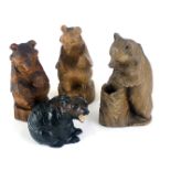 Four Black Forest style carved bears, the largest 18cm high.