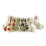 A collection of 19thC and later Staffordshire spaniels, various models to include brown and black ex