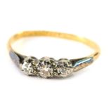 A three stone dress ring, on plain shank, marked 18ct plat, size K.