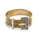 A 9ct gold buckle ring, white and yellow gold, with scroll detail and tiny diamond set, ring size X½