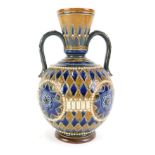 A Doulton Lambeth stoneware two handled vase, with sgraffito decoration of roundels within geometric