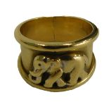 An Eastern elephant dress ring, with raised figure of an elephant with shaped ends, yellow metal sta