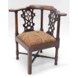 A 19thC oak corner chair, with carved back, and upholstered seat, on X frame base, 75cm high.