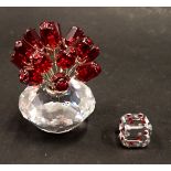 Two items of Swarovski crystal, comprising a basket of red roses, 6cm high, and a six sided dice, 1.