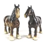 Two Beswick brown horses, each with white socks, 21cm high. (2)