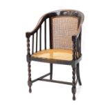 A 20thC oak bergere chair, with caned seat, on barley twist columns, with arms.