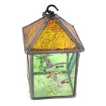 A stain glass hanging lantern, with an amber floral glass, and green panelled sides over painted wit