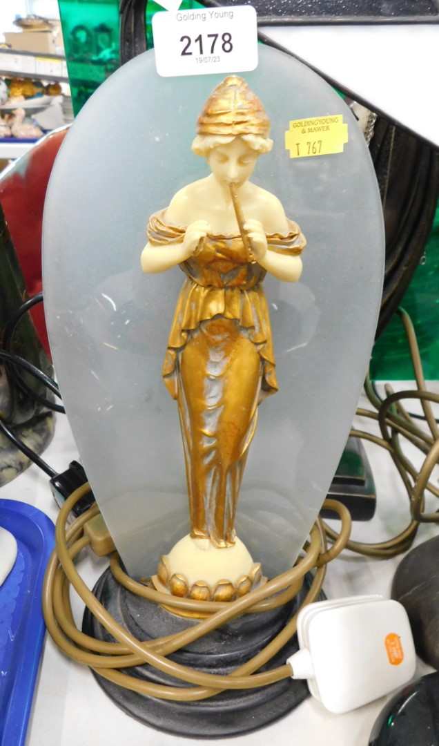 An Art Deco style table lamp, depicting resin female in gold dress.