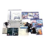 A Sony Playstation 2 slim, in silver, boxed, together with games including Tiger Woods PGA Tour 07,