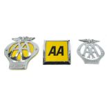 Three AA car badges.