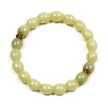 A pale jade bangle, on a yellow metal snap clasp, 25.5g.