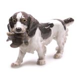 A Bing & Grondahl porcelain figure of a cocker spaniel, with a game bird in its mouth, number 2061,