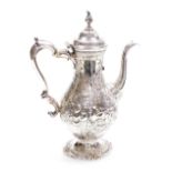An antique silver coffee pot, of baluster form, embossed with flowers and engraved with leaves, vaca