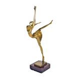 A Art Deco brass figure of a ballerina, modelled en pointe, raised on a square base, 34.5cm high.