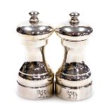 A pair of Elizabeth II loaded silver pepper grinders, crest engraved, London 1987, 8.81oz all in.