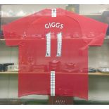 A Manchester United number 11 football shirt, signed by Ryan Giggs, with a picture of Giggs and deta