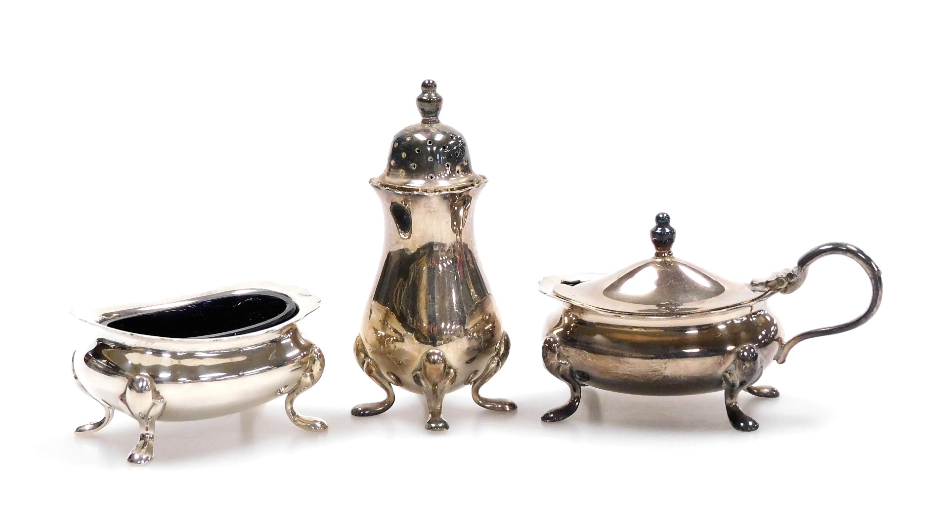 A Queen Elizabeth II silver three piece condiment set, with blue glass liners, comprising mustard po