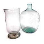 A glass carboy, 48cm high, together with a glass storm lantern, 40cm high. (2)