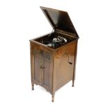 An early 20thC Minster oak cased cabinet gramophone, with winder, 79cm high, 44cm wide, 51cm deep.