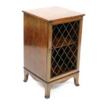 An Edwardian mahogany and crossbanded pot cupboard, with a brass grille door, raised on outswept fee