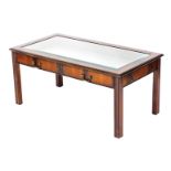 A Table Place Limited mahogany bijouterie table, with a bevelled glass top, above two dummy drawer f