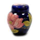 A Moorcroft pottery Magnolia pattern ginger jar and cover, on a blue ground, impressed marks, 10.5cm