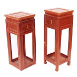 A pair of Chinese graduated red lacquer side tables, or urn stands, each with a single frieze drawer