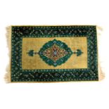 A Turkish isparta cream ground rug, decorated with central green floral medallion, within repeating