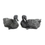 A pair of black plaster figures of ducks, 32cm wide.