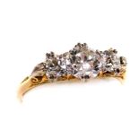 An 18ct gold and diamond three stone ring, centre diamond approximately 1.05ct, two further diamonds