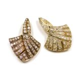 A pair of Art Deco diamond brooches, of scrolling, fan shaped form, set with rose and old cut diamon