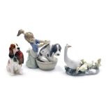 A Royal Doulton porcelain figure of a cocker spaniel, modelled seated with a pheasant in its mouth,